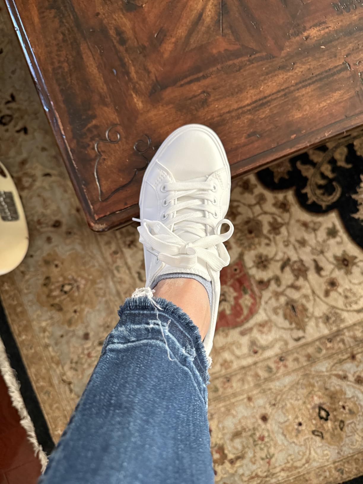 Close-up view of SERNIAL white sneaker showing sole pattern and construction details