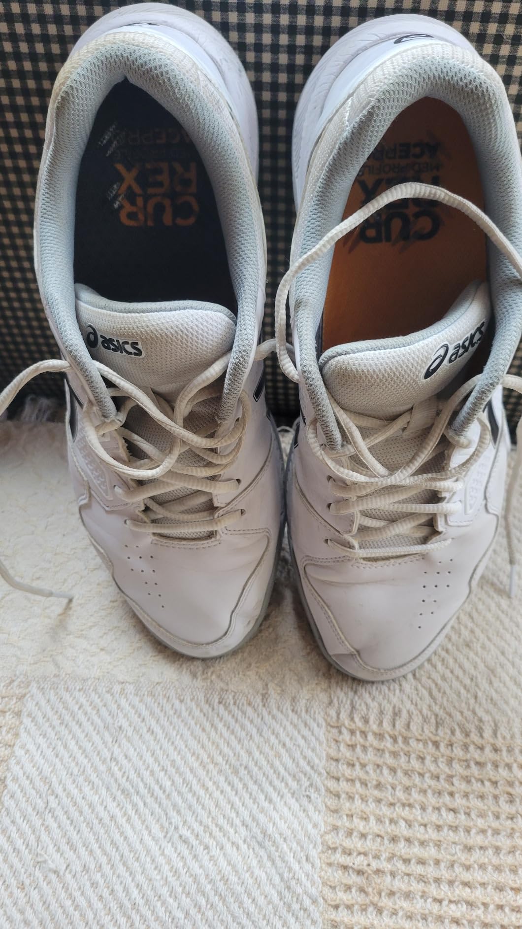 ASICS tennis shoes during court play showing lateral movement and traction