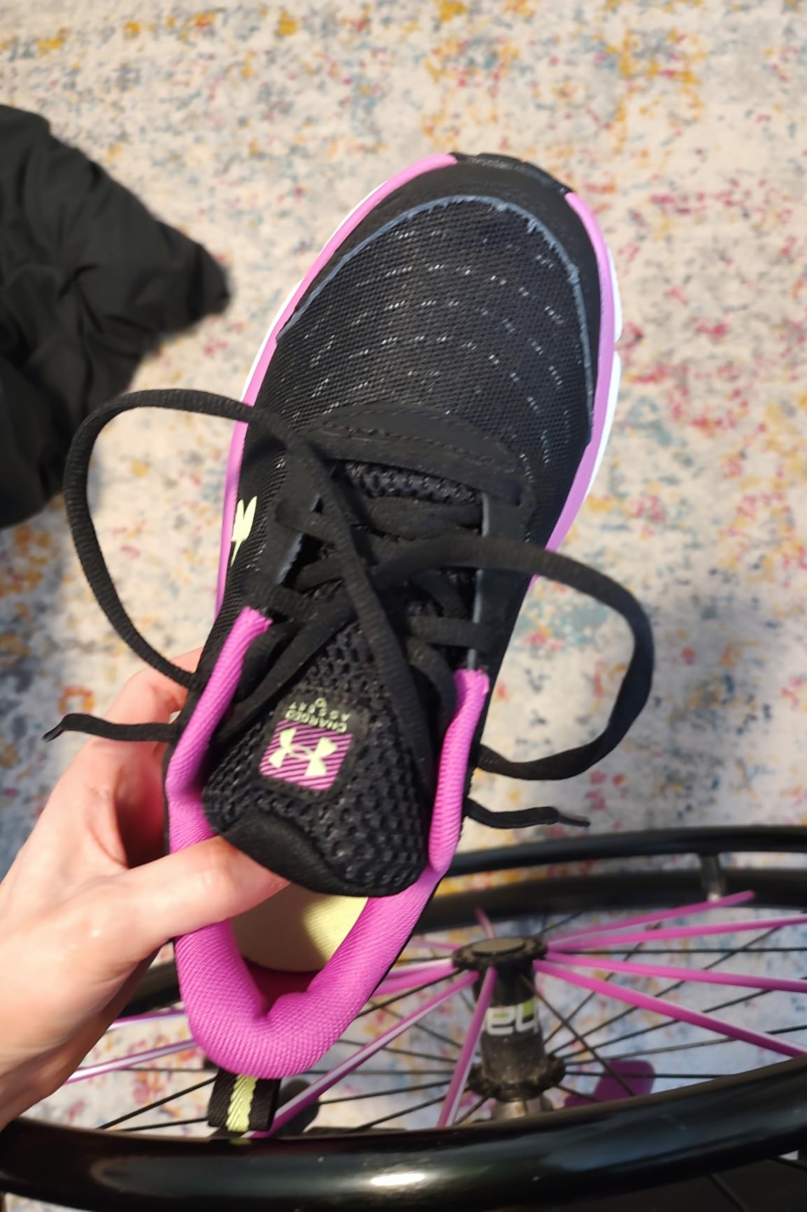 Close-up view of Under Armour Assert 10 synthetic overlays and mesh construction details