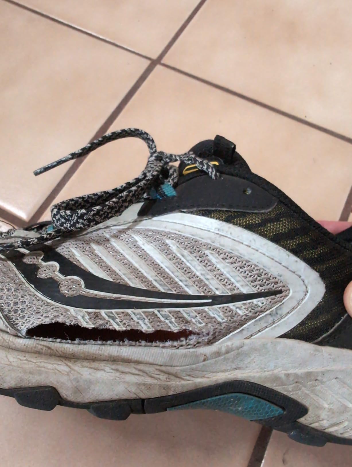 Side view of Saucony TR15 showing worn condition after extensive trail testing with visible durability issues