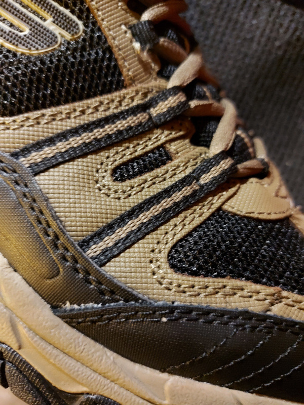Close-up view of Skechers After Burn upper construction showing leather and synthetic materials with lacing system