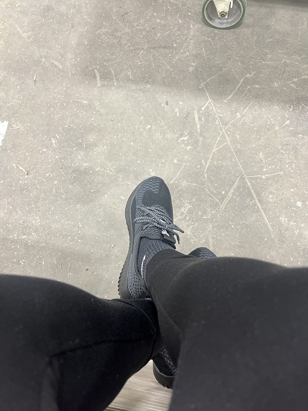 Close-up view of SUADEX steel toe shoes showing mesh upper construction and protective toe cap