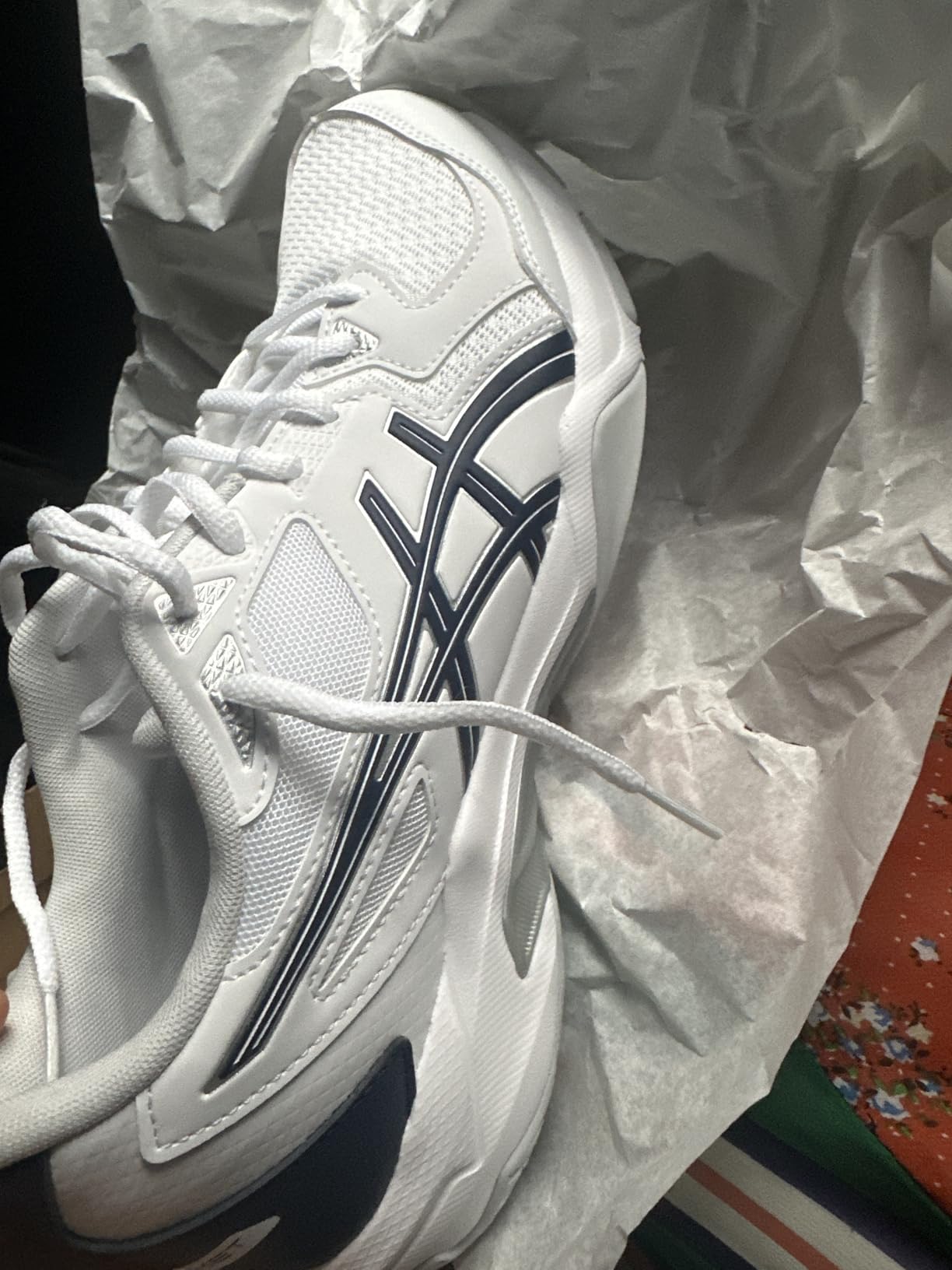 ASICS Gel-Rocket 10 side profile showing mesh upper and heel wrap design