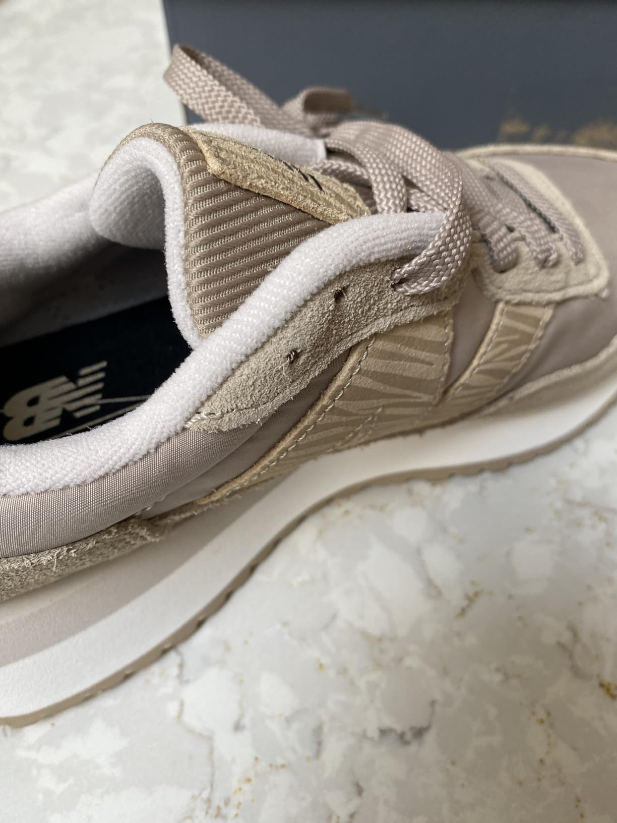 Close-up of New Balance 237 upper construction showing mesh and suede materials