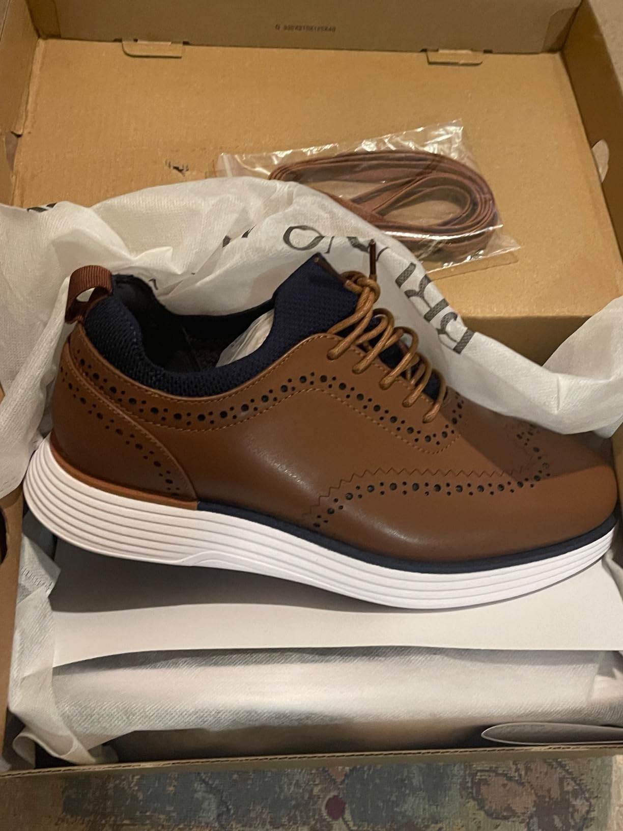 Final product shot showing Bruno Marc dress sneakers in professional setting