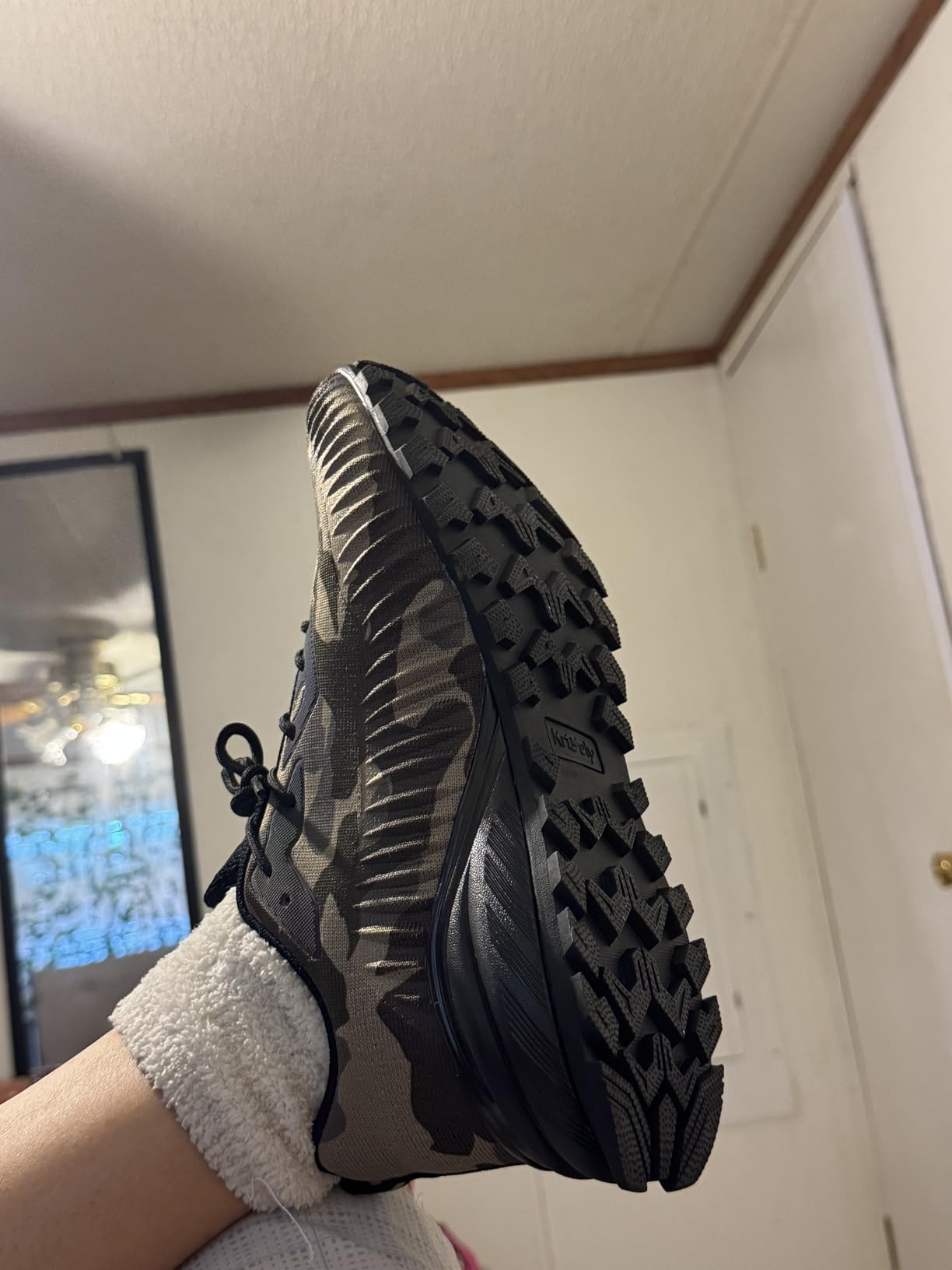 Bottom sole showing natural rubber construction with flexible groove traction pattern