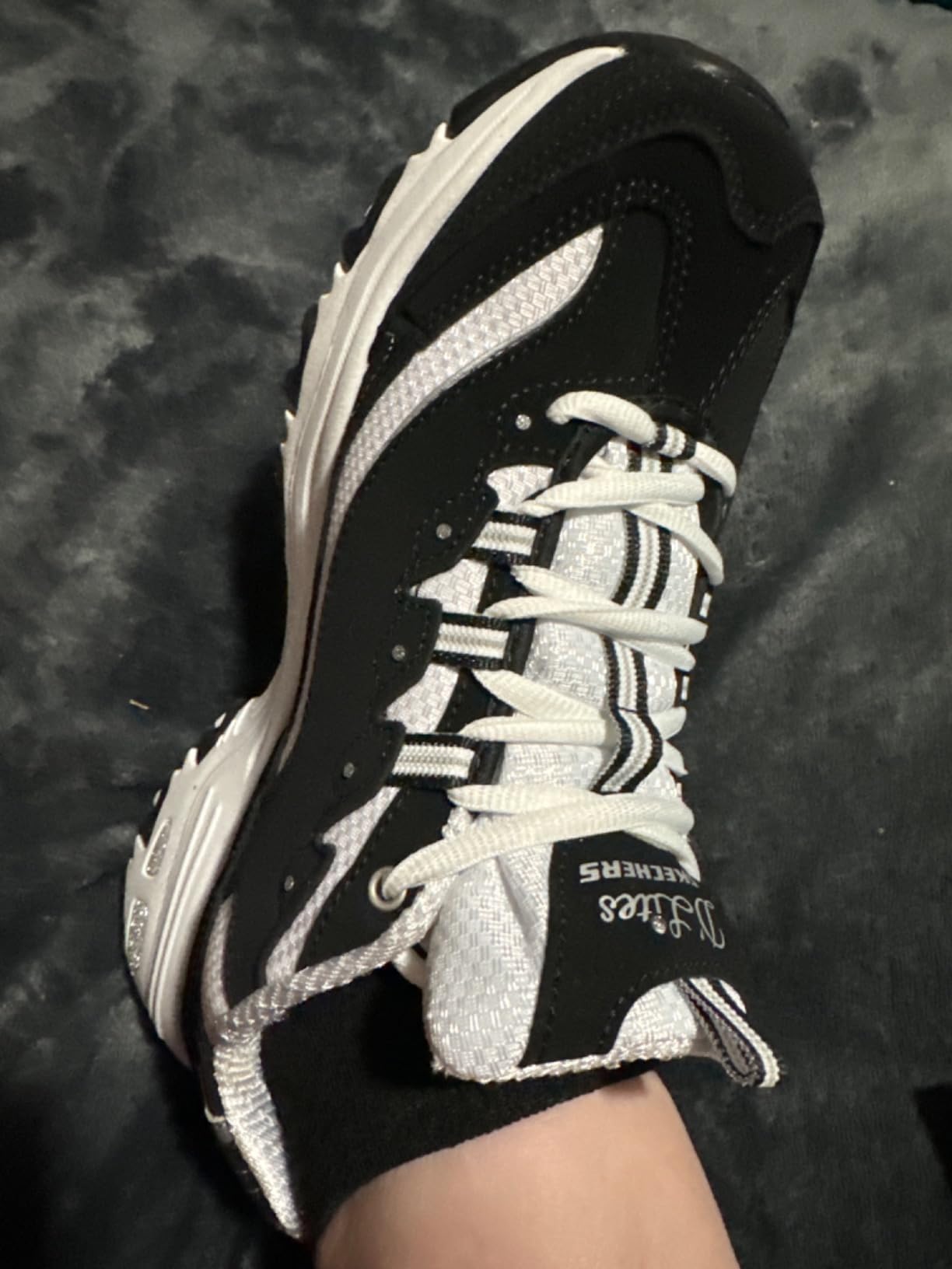 Detailed view of Skechers D'Lites features including Air-Cooled Memory Foam insole and supportive midsole design