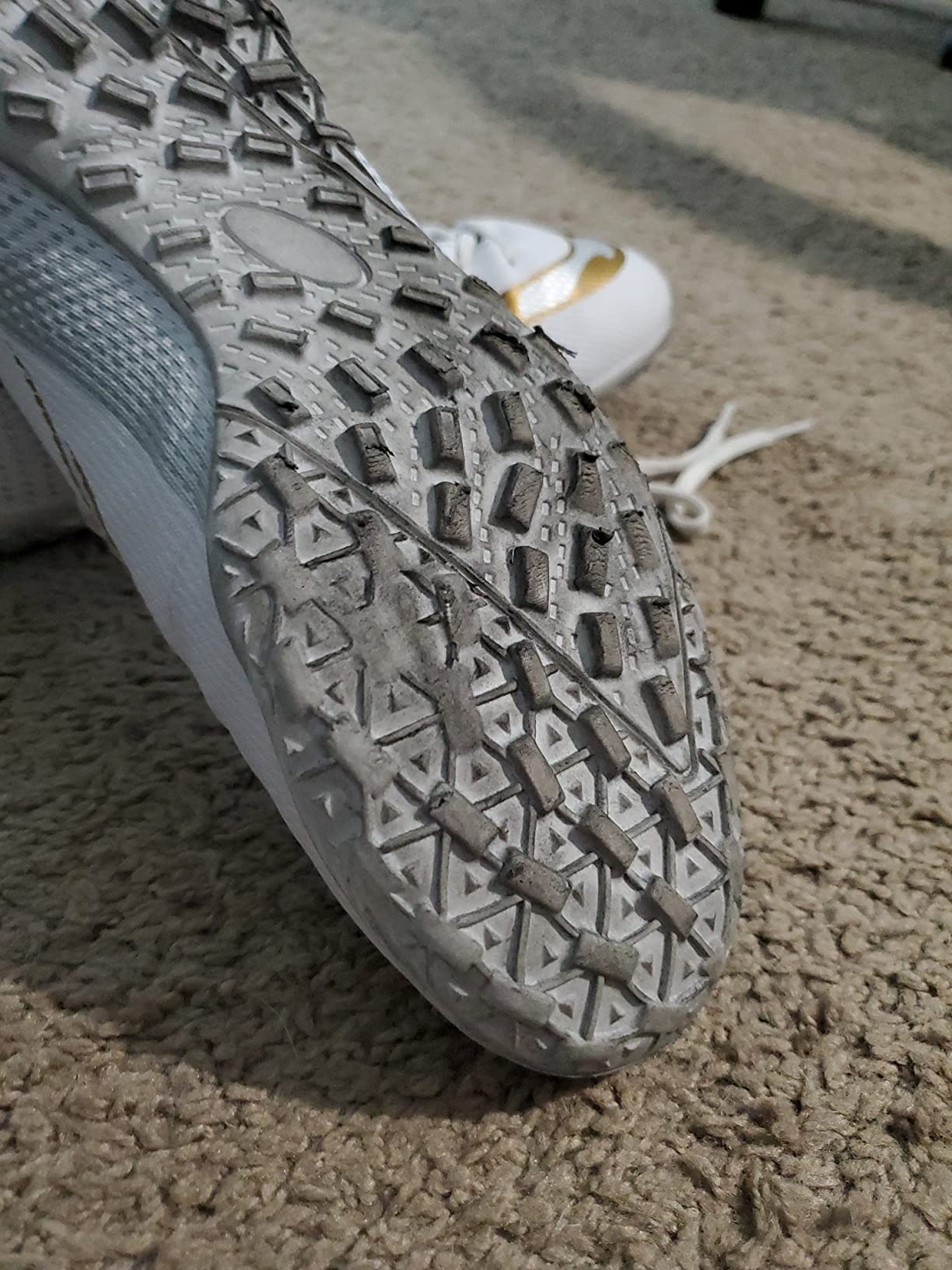 Testing HaloTeam soccer cleats on different surfaces showing traction performance on grass and turf