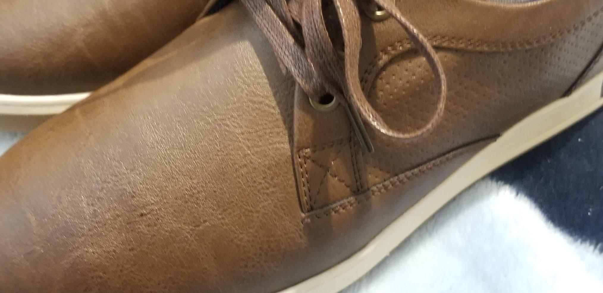 Close-up of Vostey sneaker showing PU leather upper construction and stitching details
