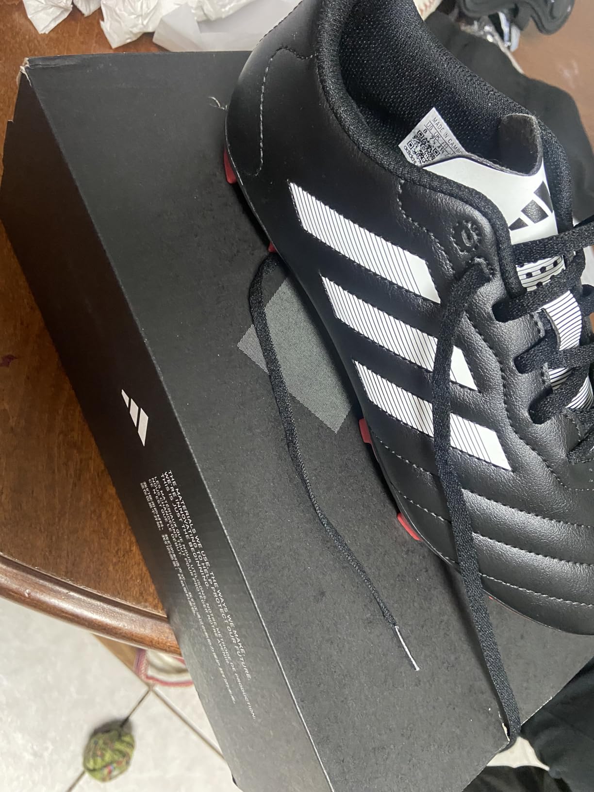 Adidas Goletto VII cleats on grass field showing real-world usage conditions