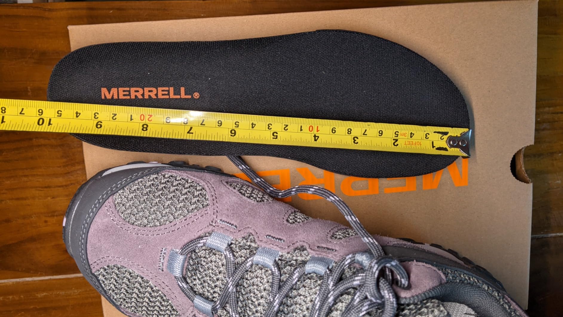 Final product shot of Merrell Women's Yokota 2 hiking shoes with gear layout