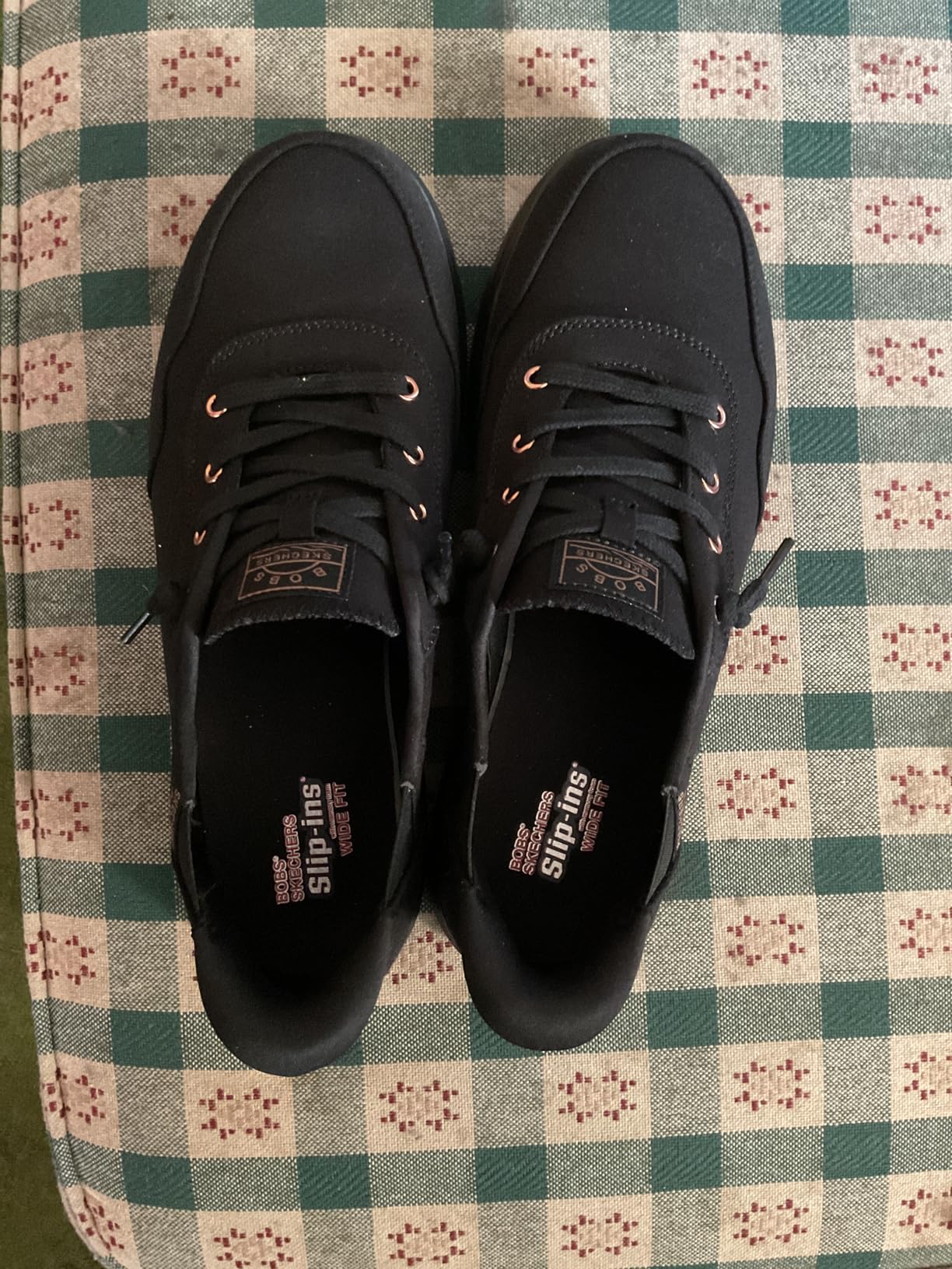 Skechers slip-in sneakers from side angle showing heel pillow design and overall silhouette