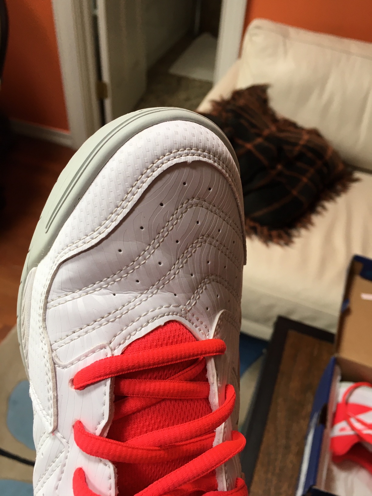 Bottom view of ASICS tennis shoes showing sole wear pattern and tread design after months of court use