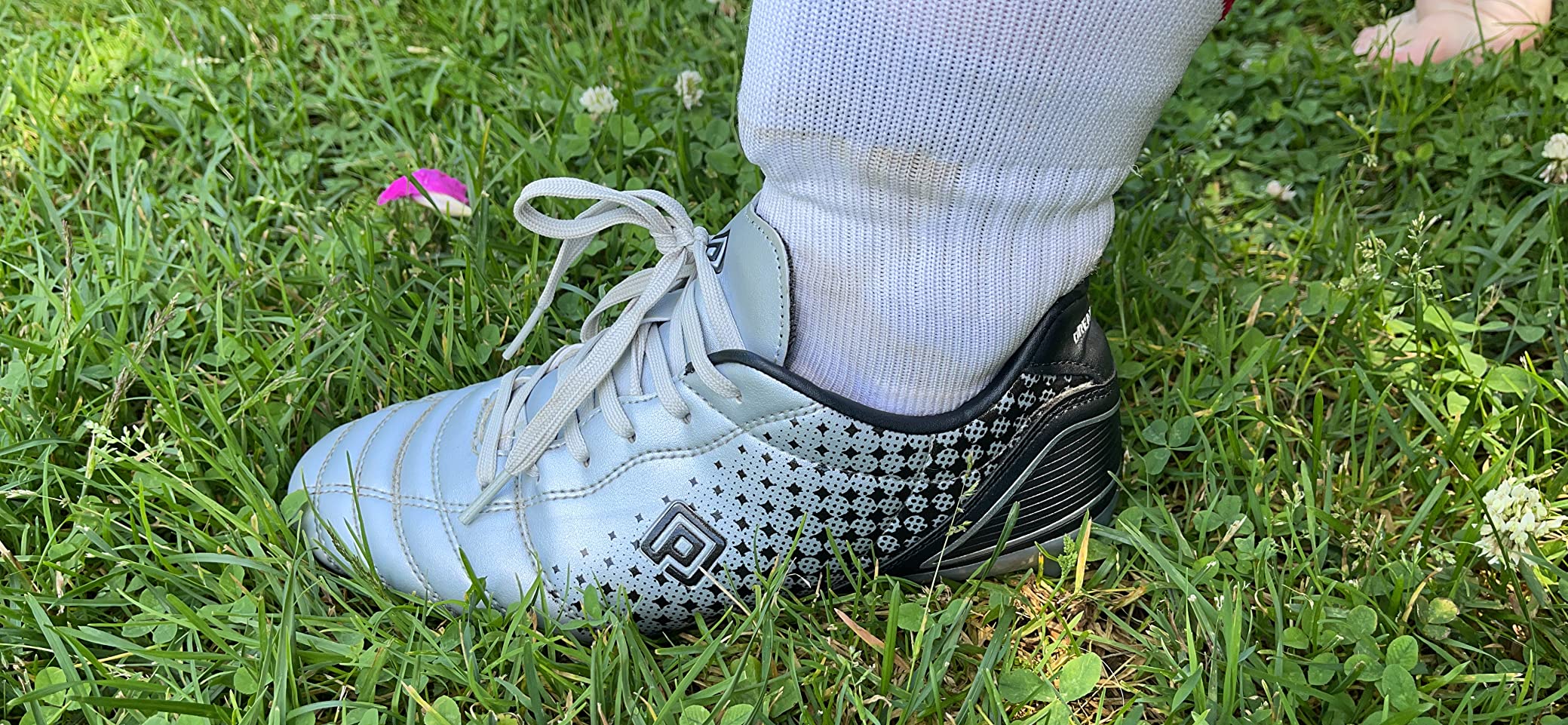 Side profile view of DREAM PAIRS cleats showing high ankle design and overall construction