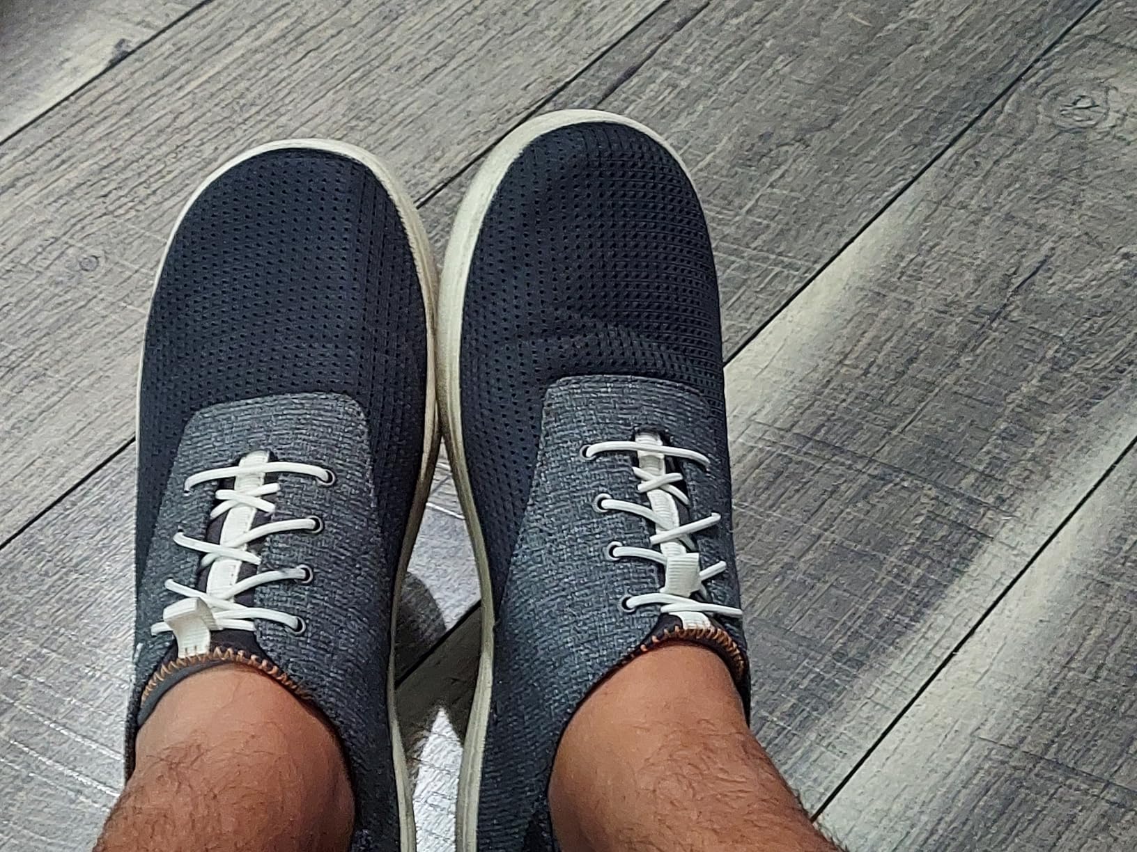 Close-up detail of OLUKAI Nohea Moku showing breathable mesh upper construction and fold-down heel design