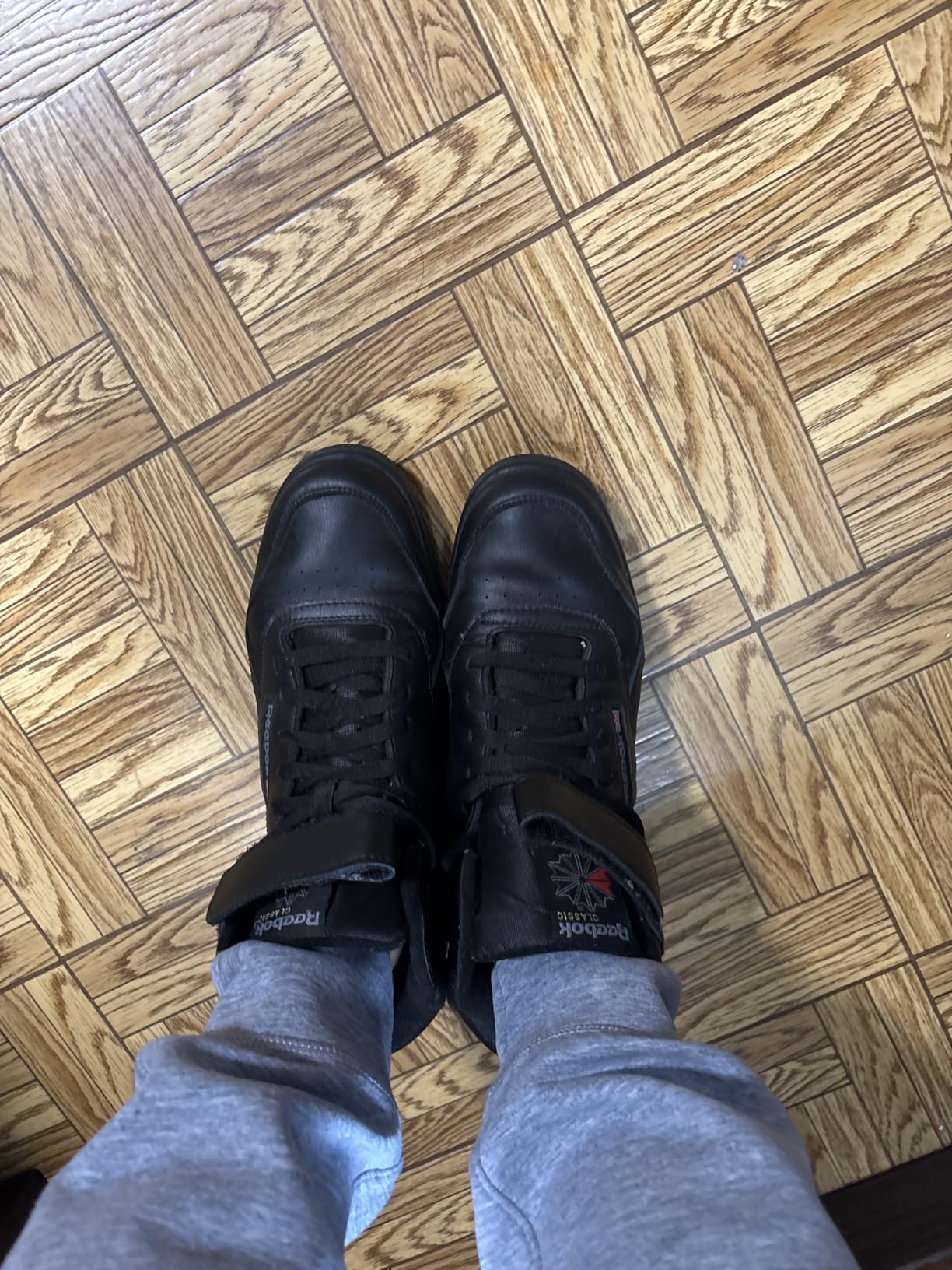 Close-up of Reebok EX-O-FIT HI showing leather upper construction and velcro ankle strap detail