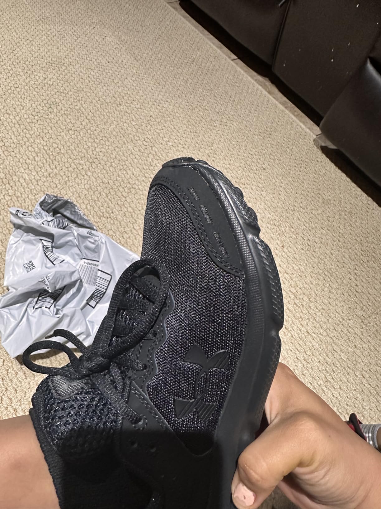 Under Armour Assert 10 brand logo and quality construction details close-up