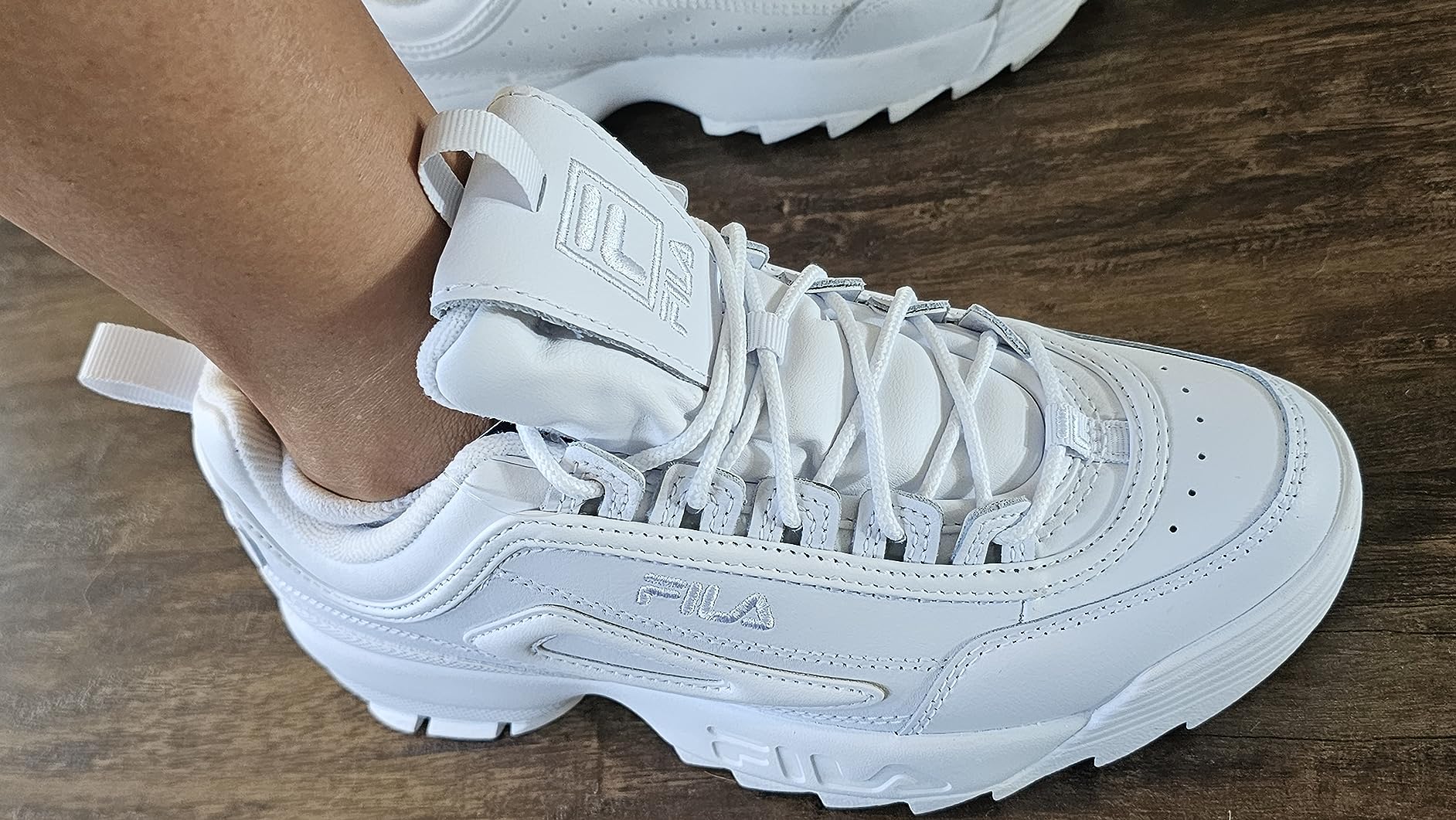 Close-up of Fila Disruptor II lacing system and ankle collar padding detail