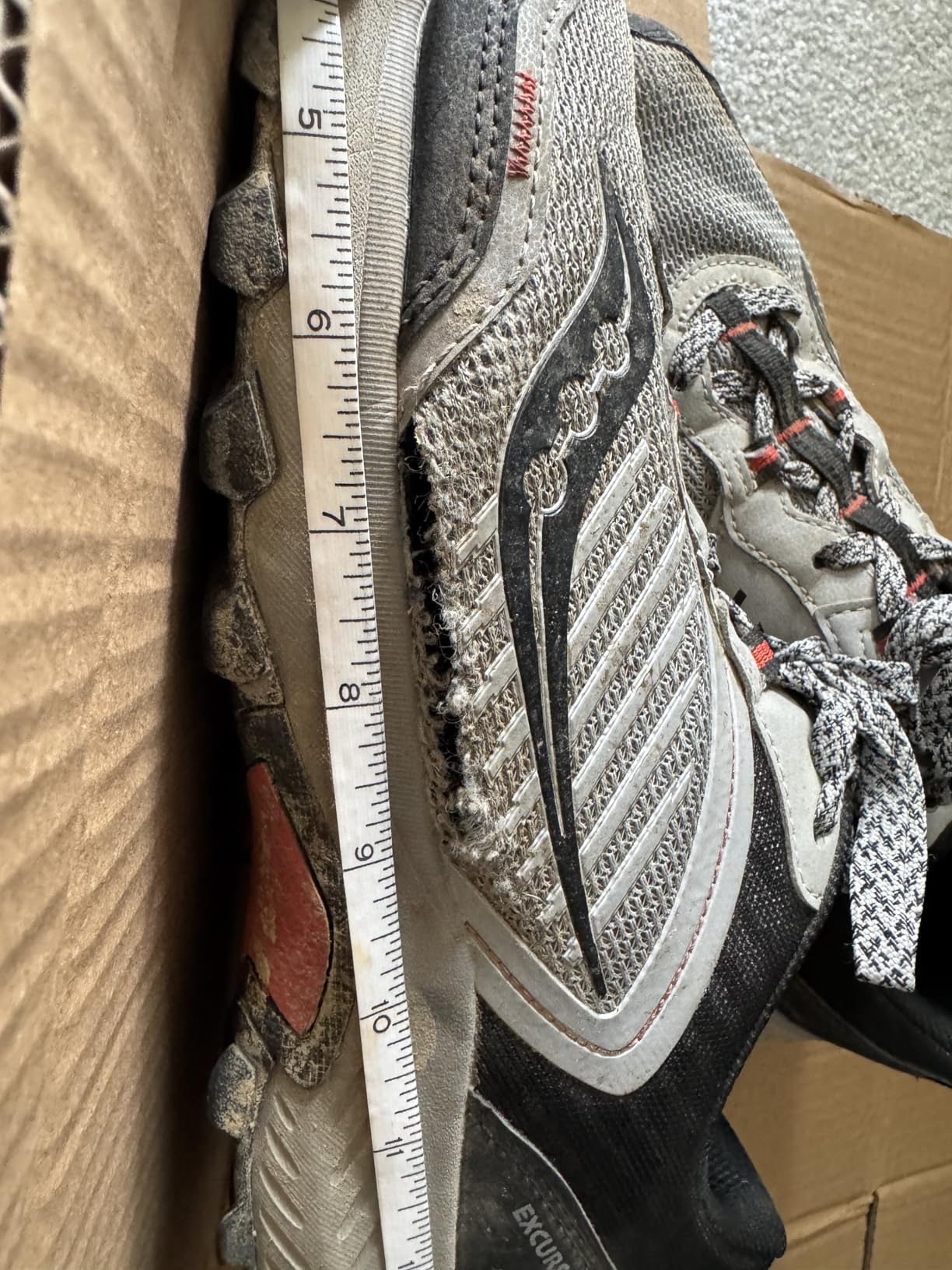 Detailed view of mesh upper deterioration on Saucony TR15 showing common failure point