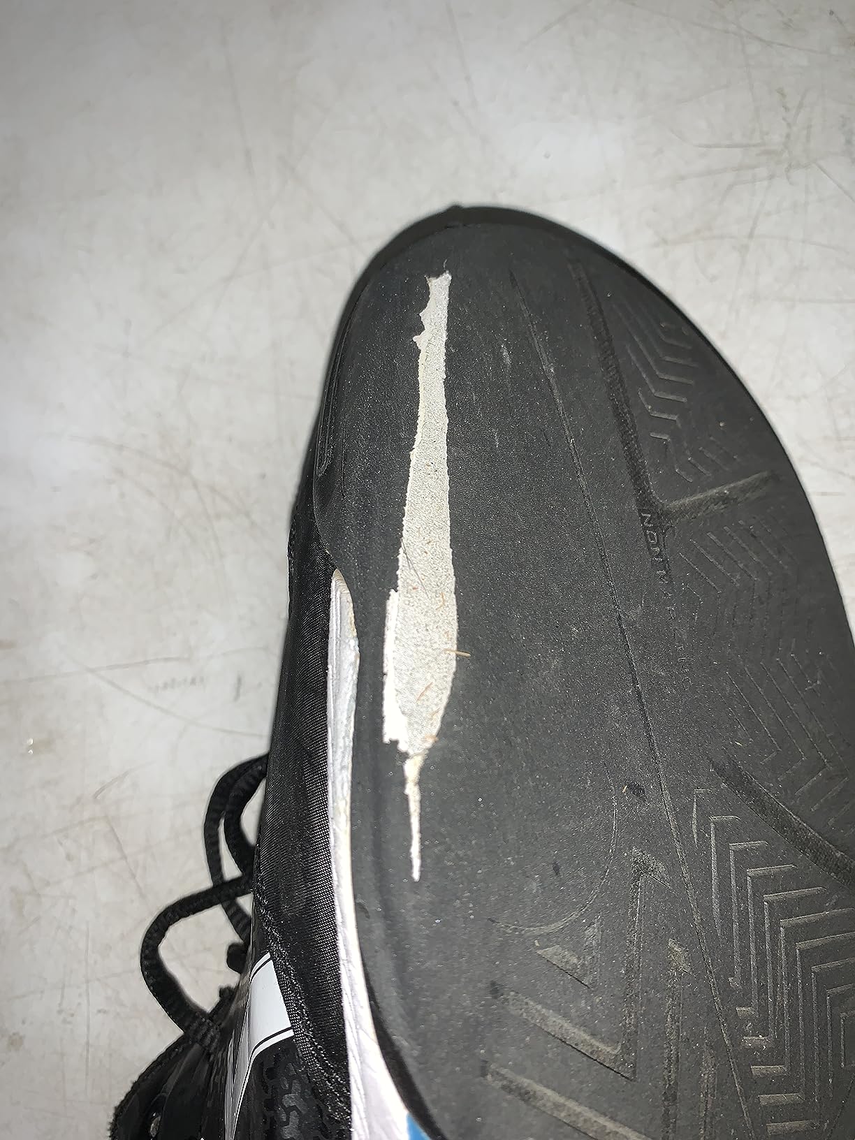 Multiple ASICS tennis shoes showing various wear patterns and durability issues