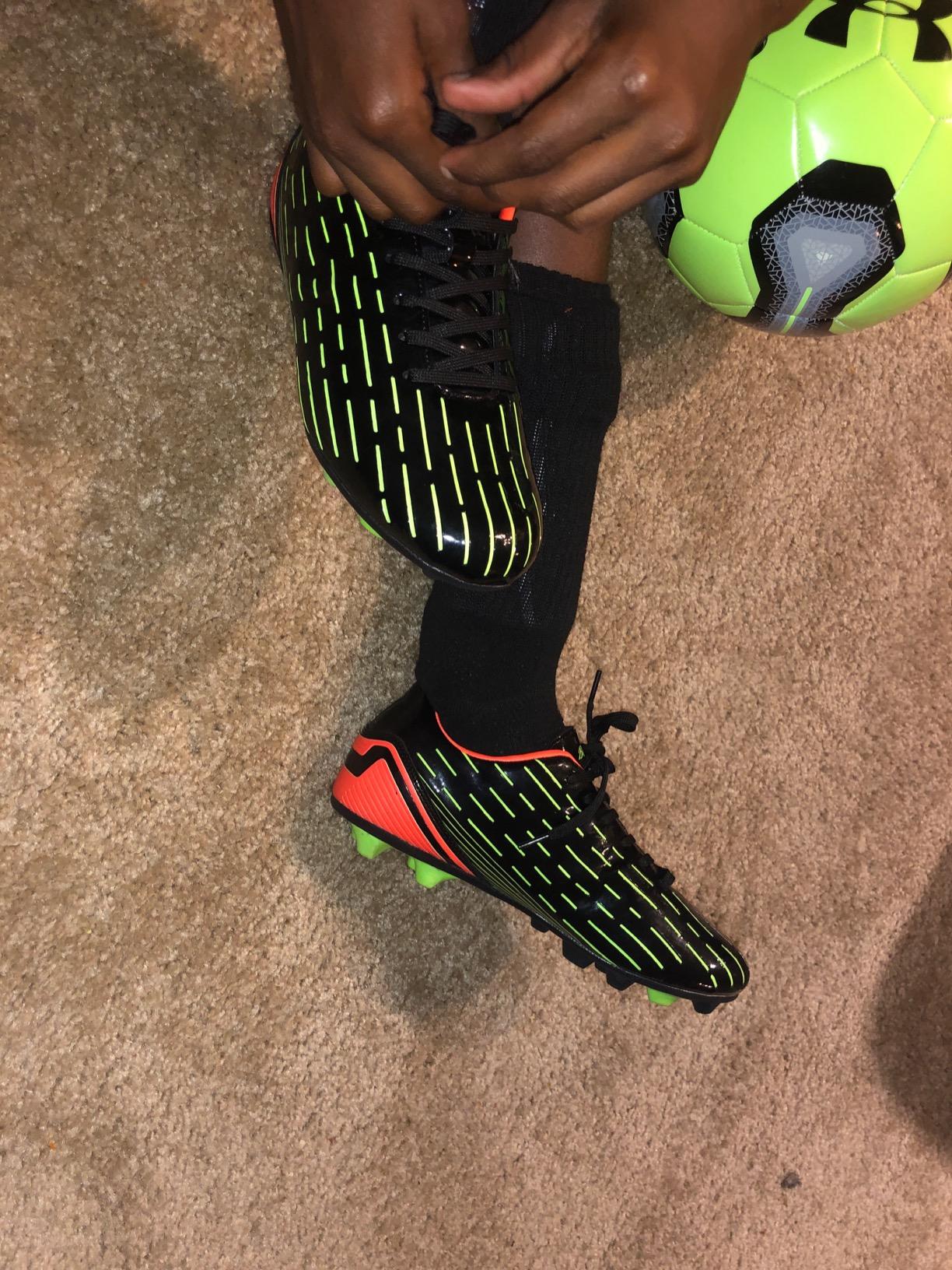 BomKinta kids soccer cleats in action on soccer field showing real-world performance
