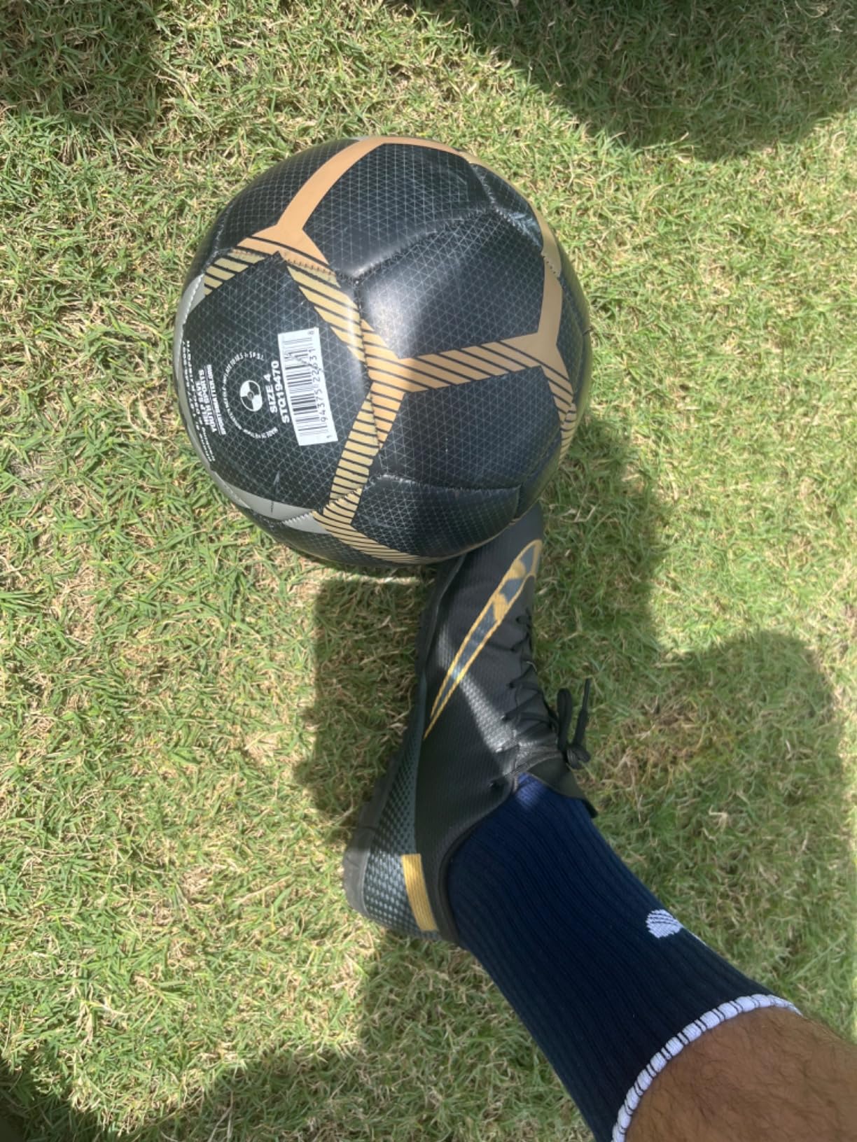 Side profile of HaloTeam soccer cleats showing high-top design and stud pattern for turf and grass surfaces