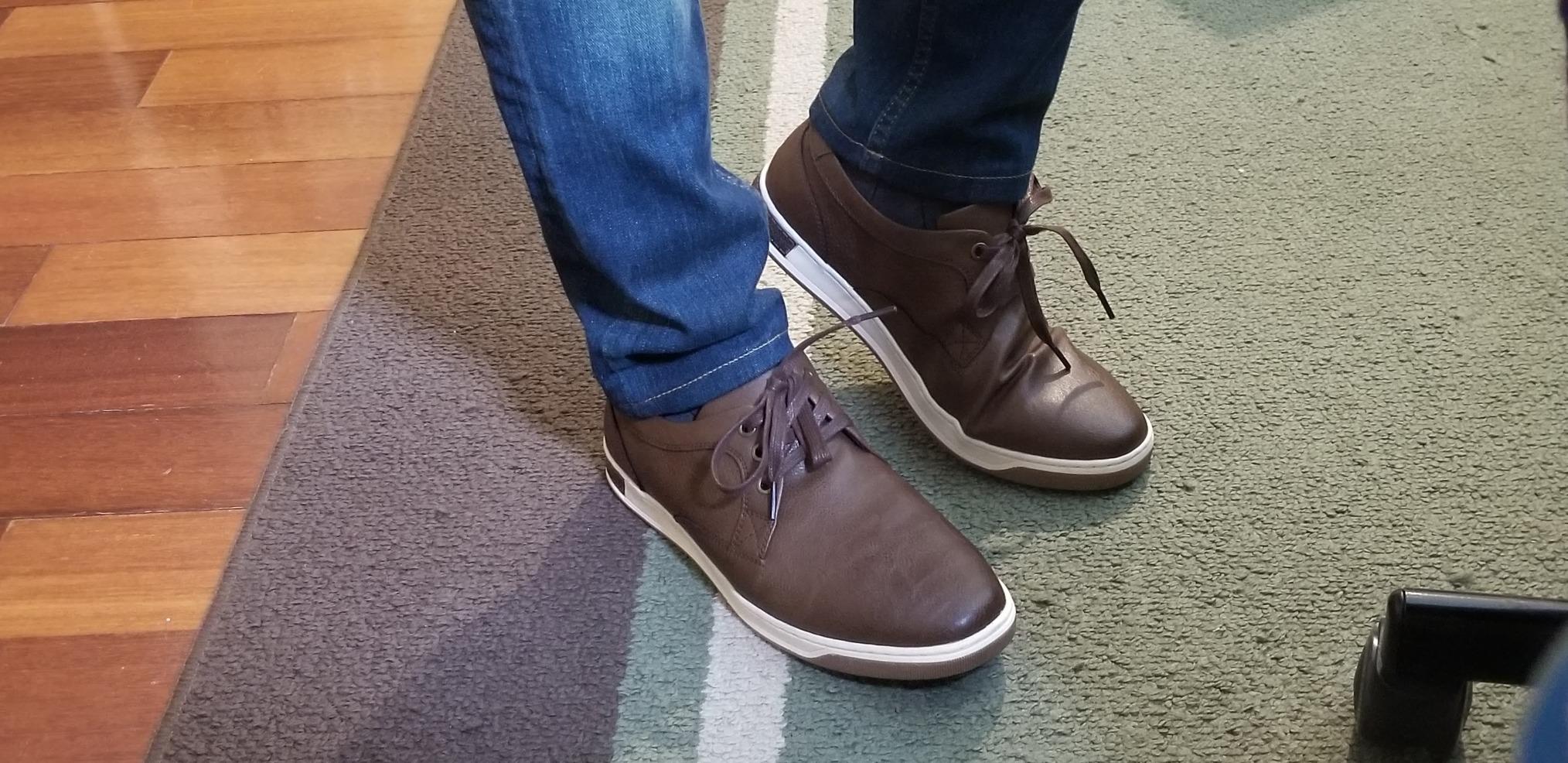 Side profile view of Vostey men's sneaker showing sleek silhouette and oxford-style design elements