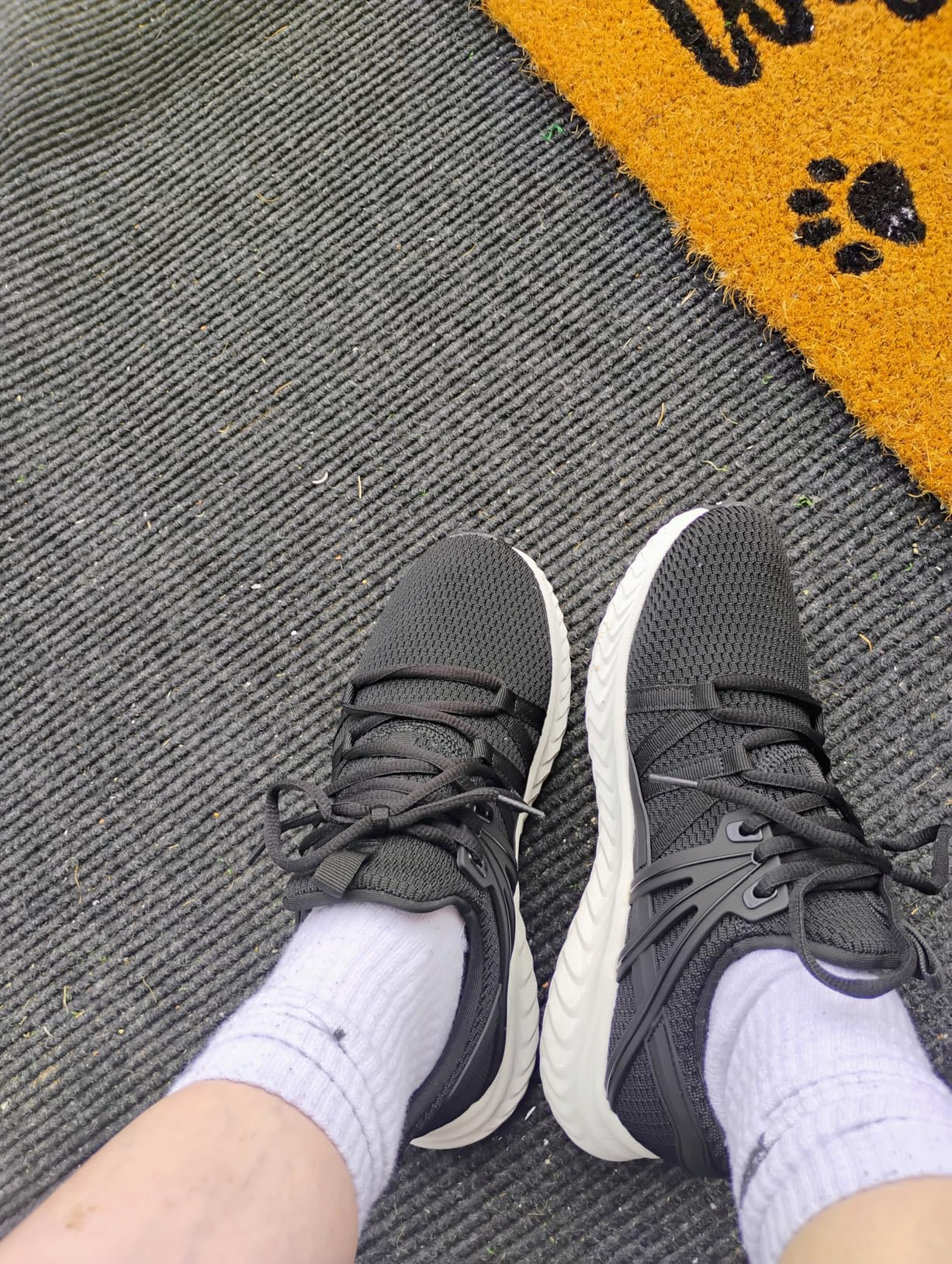 Close-up view of Abboos sneakers showing knit upper texture and slip-on design details