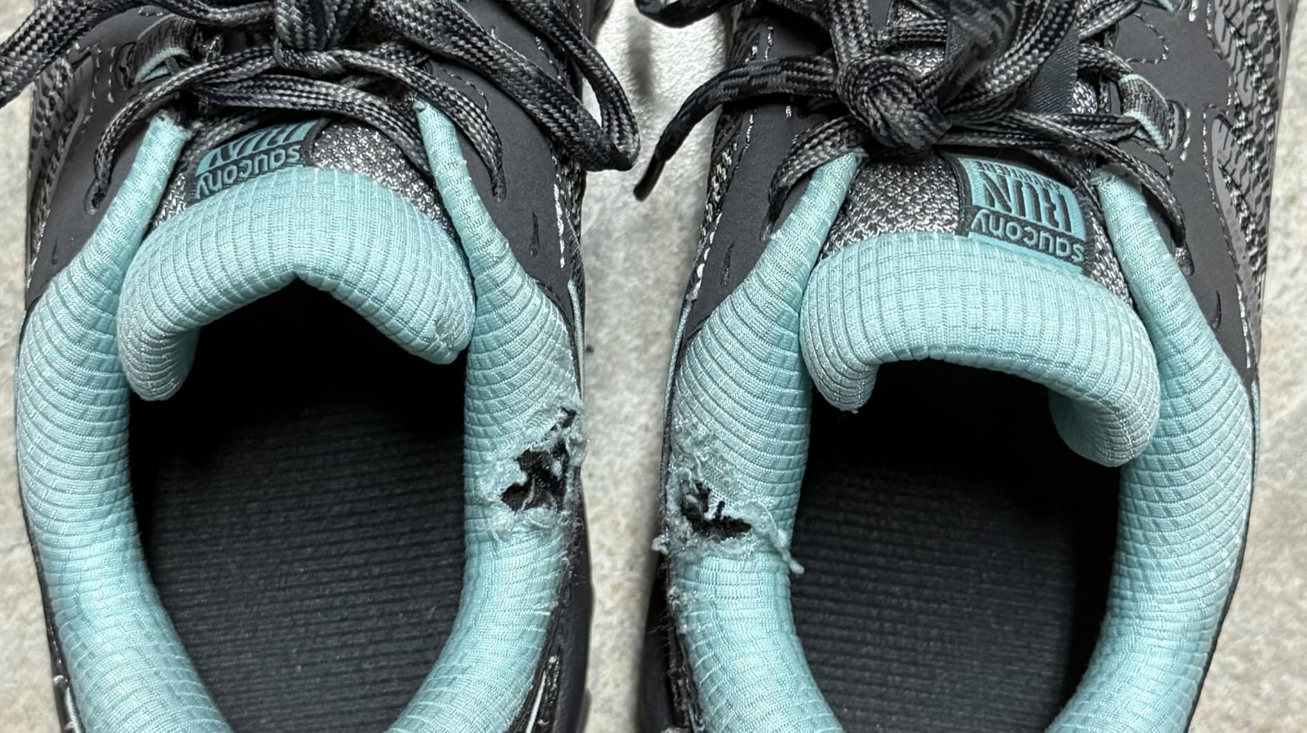 Close-up showing fabric durability issues around ankle area of Saucony TR13