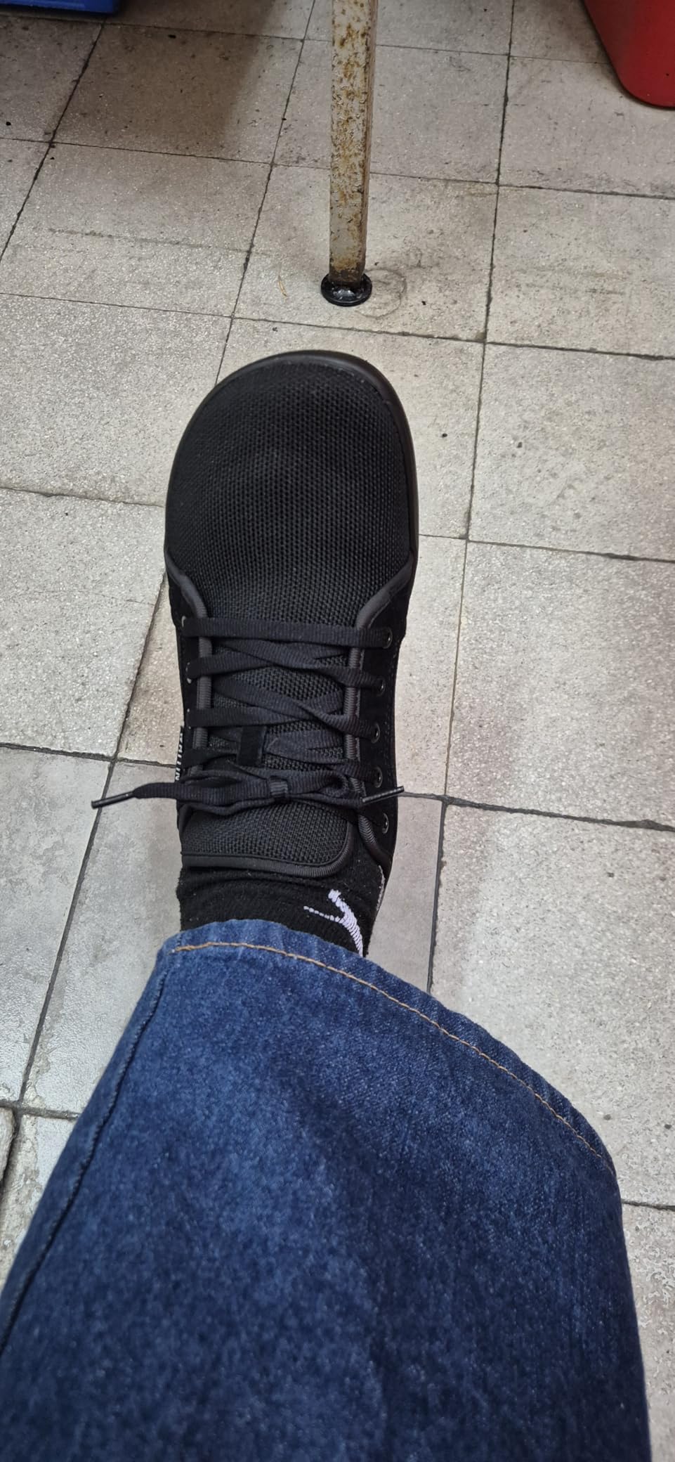 Bottom view of WHITIN sneaker showing rubber sole tread pattern