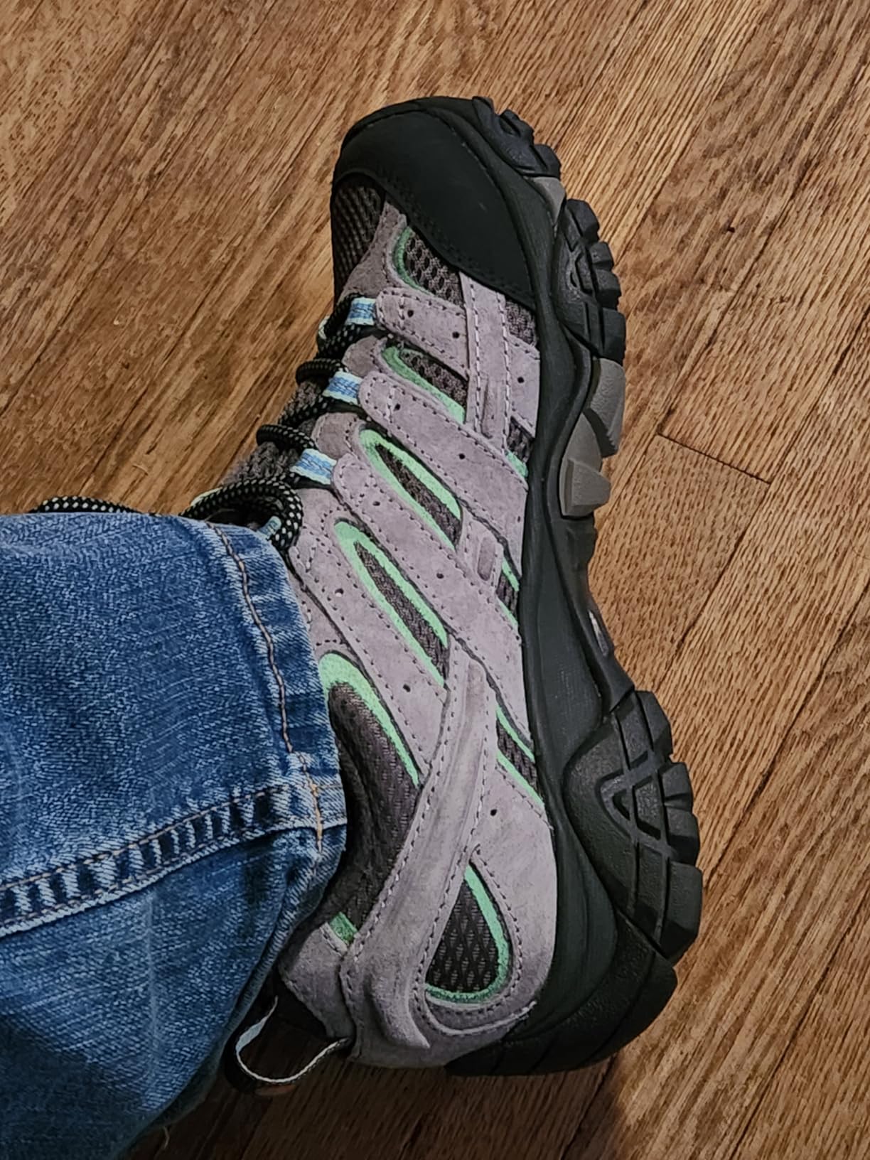Close-up detail of Merrell Moab 2 leather and mesh upper construction showing protective toe cap and traditional lacing system