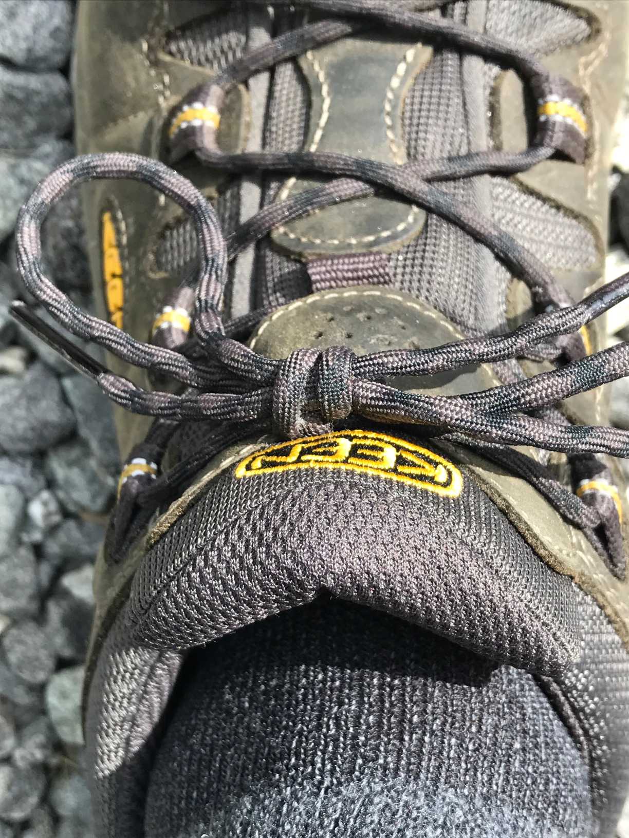 KEEN Targhee II in action on rocky trail showing ankle height and toe protection in use