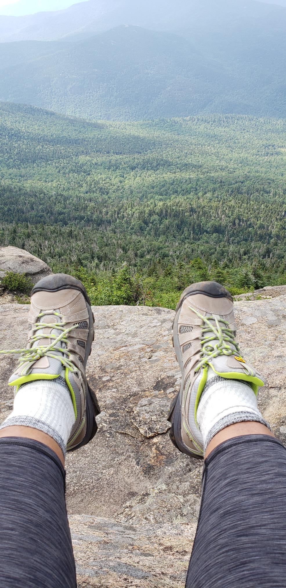 KEEN Voyageur hiking shoes in action on rocky trail terrain showing 4mm lug traction pattern