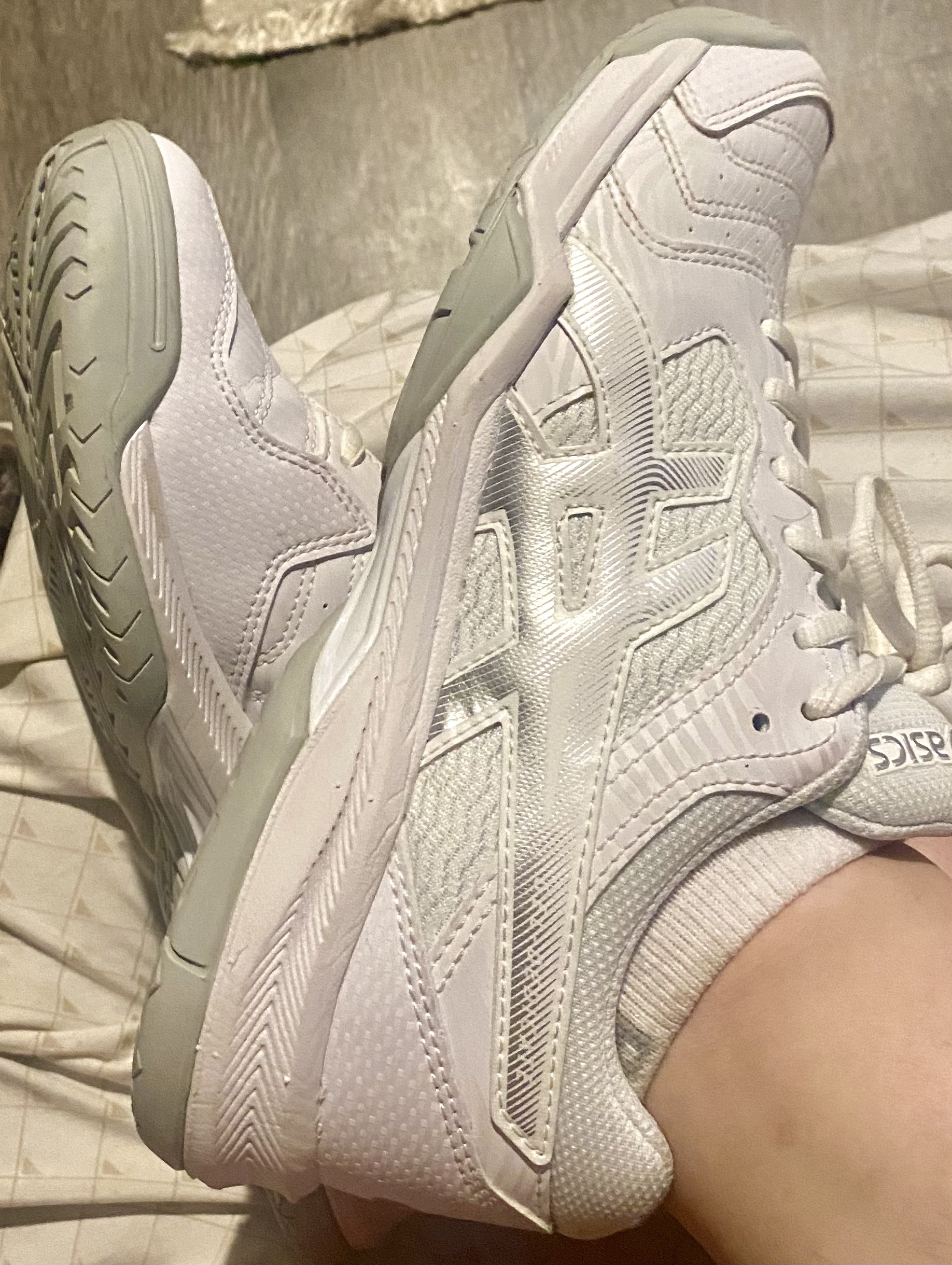 ASICS women's tennis shoes lifestyle shot showing attractive grey and pink design suitable for court and casual wear