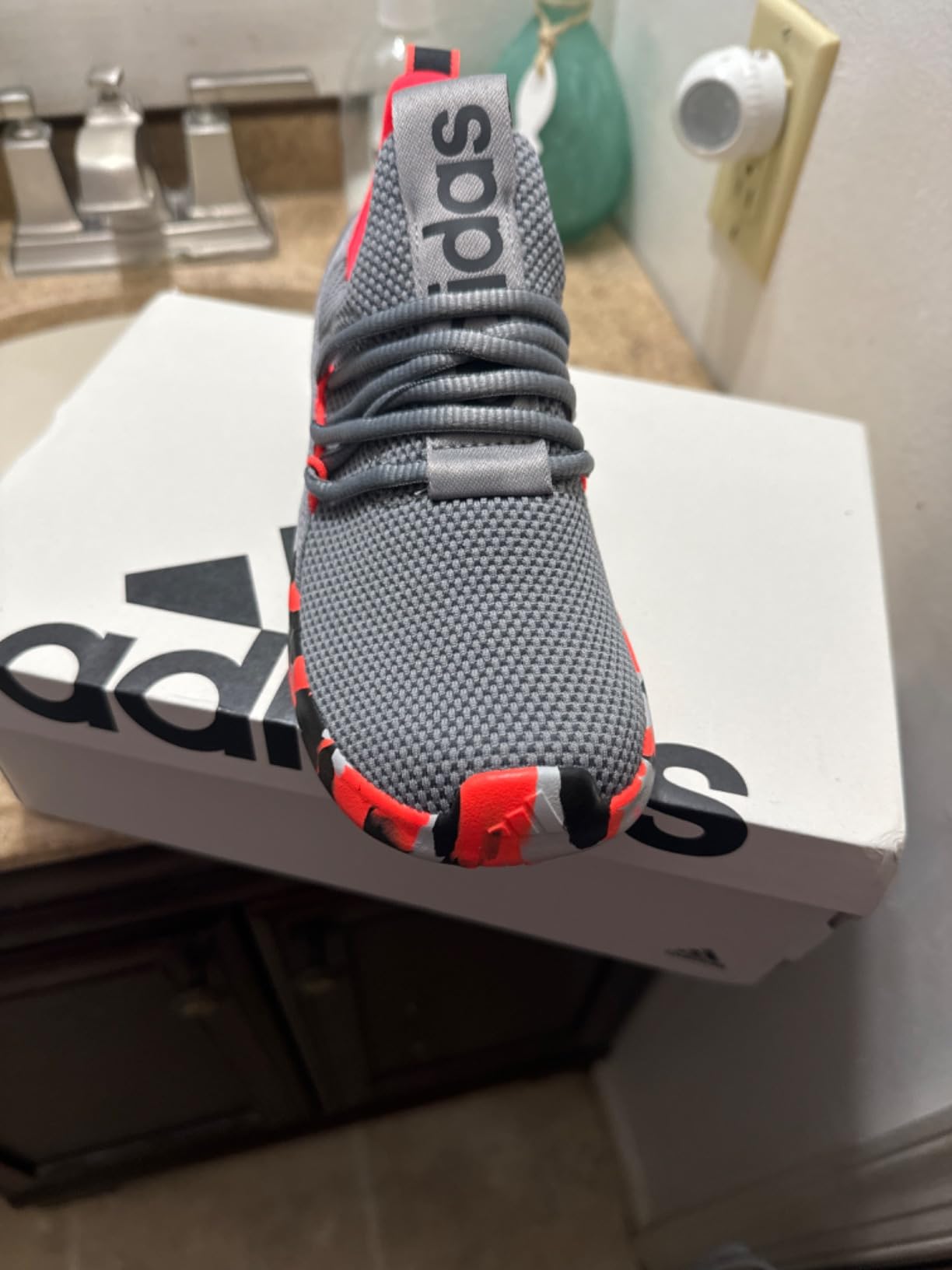 Close-up view of Adidas Lite Racer Adapt showing Cloudfoam midsole and synthetic rubber outsole