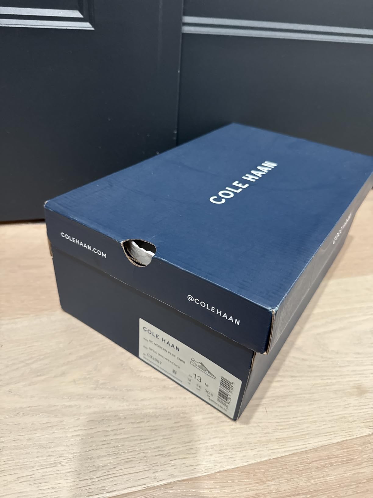 Cole Haan Men's Grand Crosscourt Modern Perforated Sneaker main product view showing leather upper and white sole