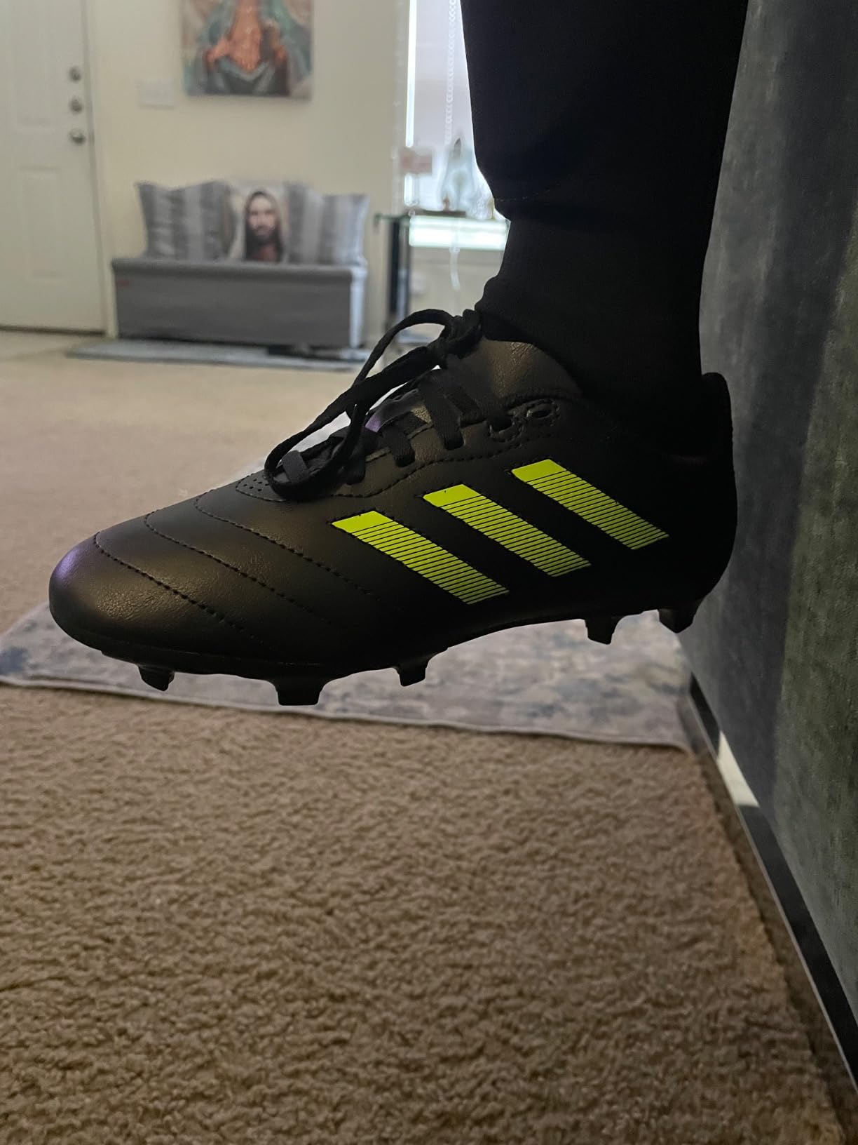 Adidas Goletto VII FG kids soccer cleats black and blue colorway showing firm ground sole design