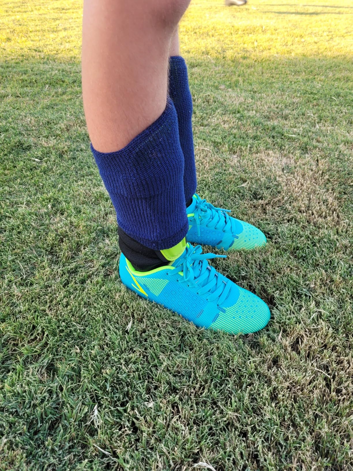 Kids soccer cleats in action showing performance on grass field during youth soccer