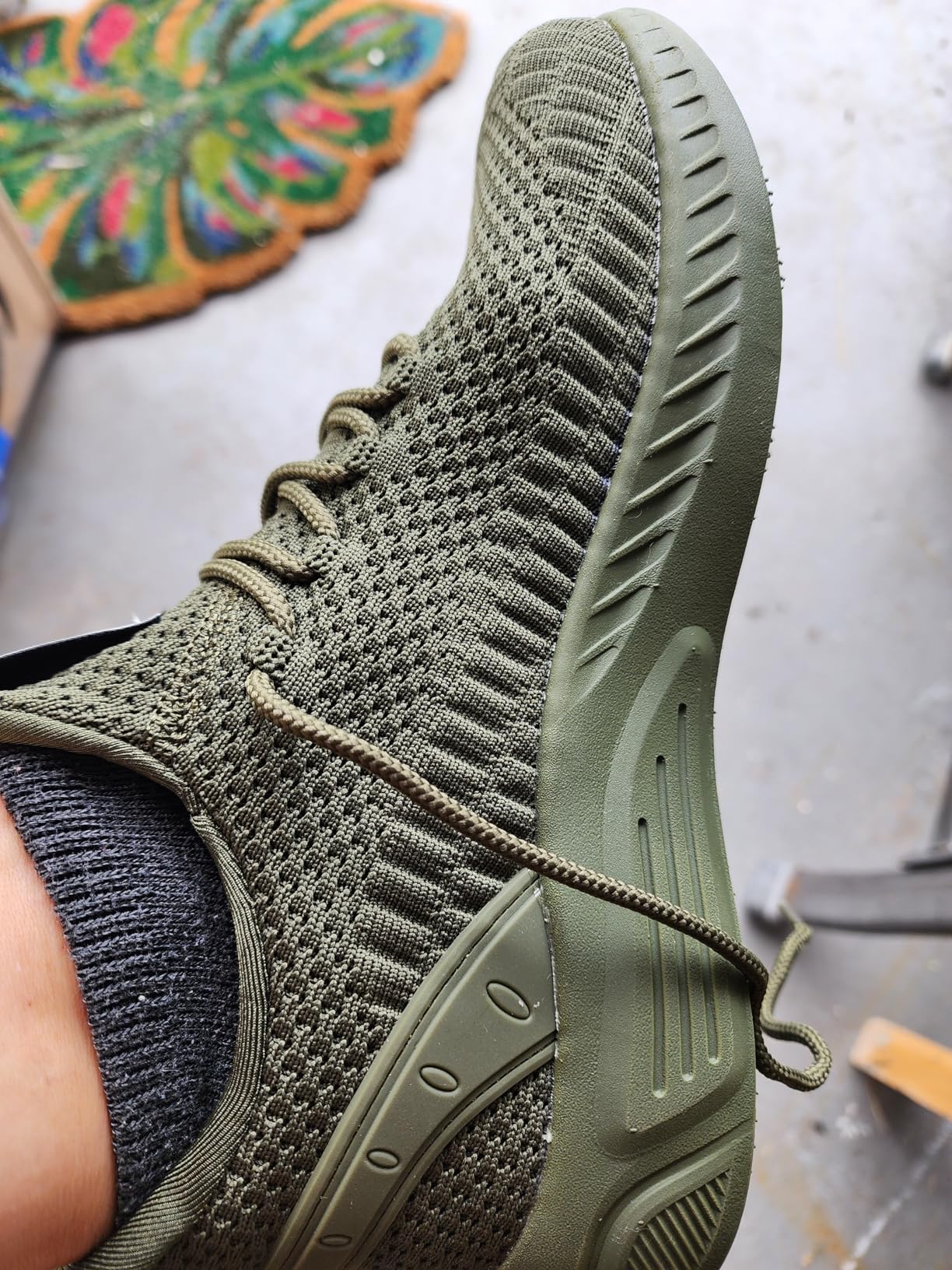 Close-up view of Feethit sneakers showing mesh upper construction and lacing system detail