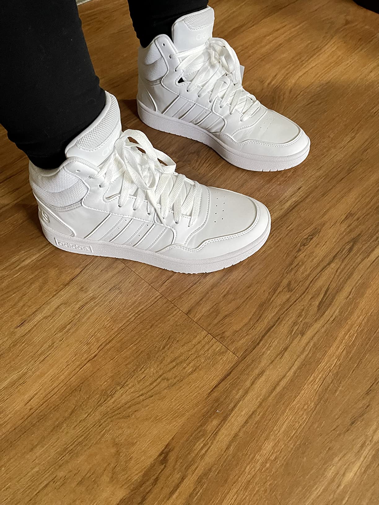 Adidas Hoops 3.0 Mid detail shot showing synthetic leather upper and three stripes design