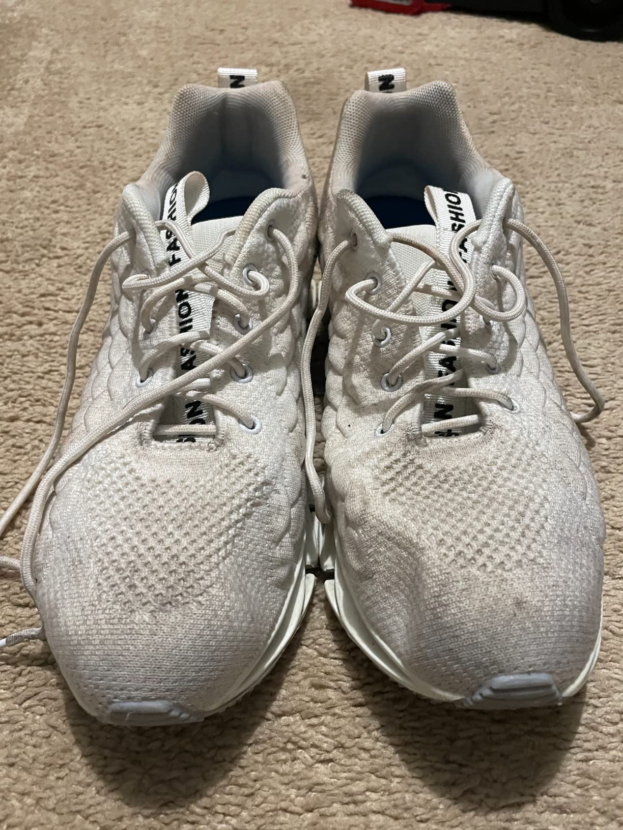 Close-up detail of SKDOIUL sneaker sole wear and tread pattern showing real-world usage effects