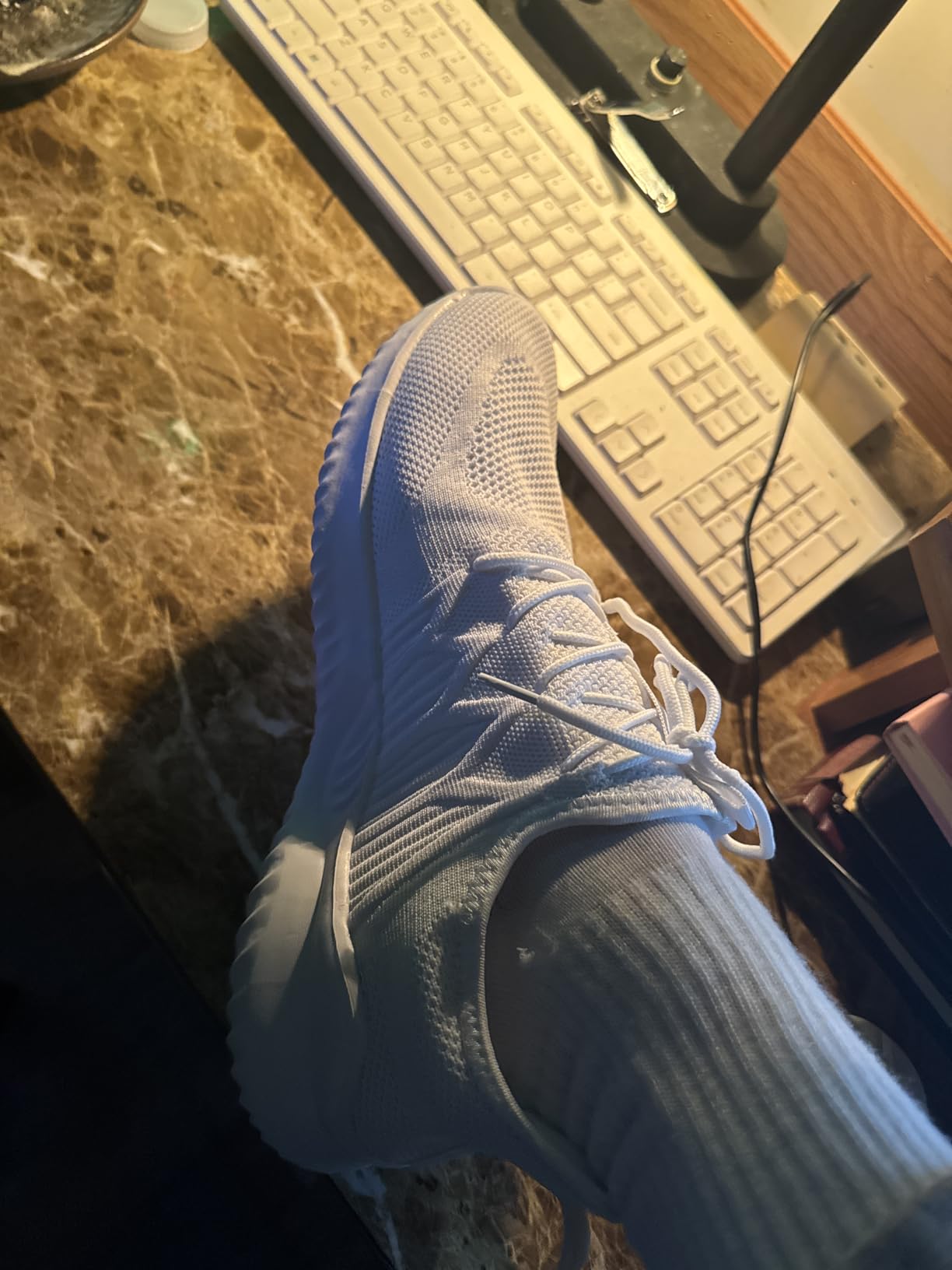 Close-up of mesh upper construction showing breathable knitted fabric and elastic design