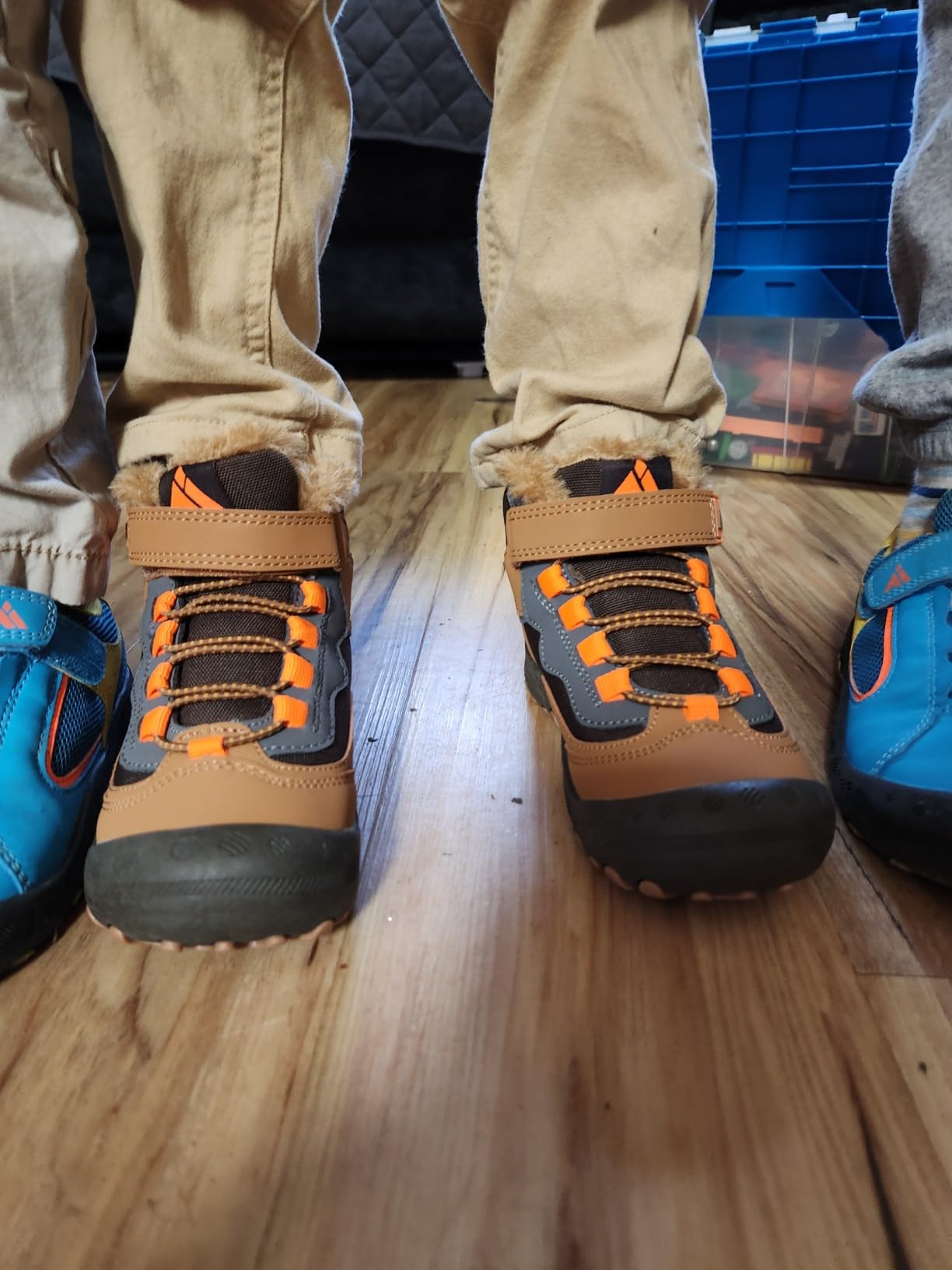Action shot of child wearing Mishansha hiking boots on rocky trail showing traction and outdoor performance